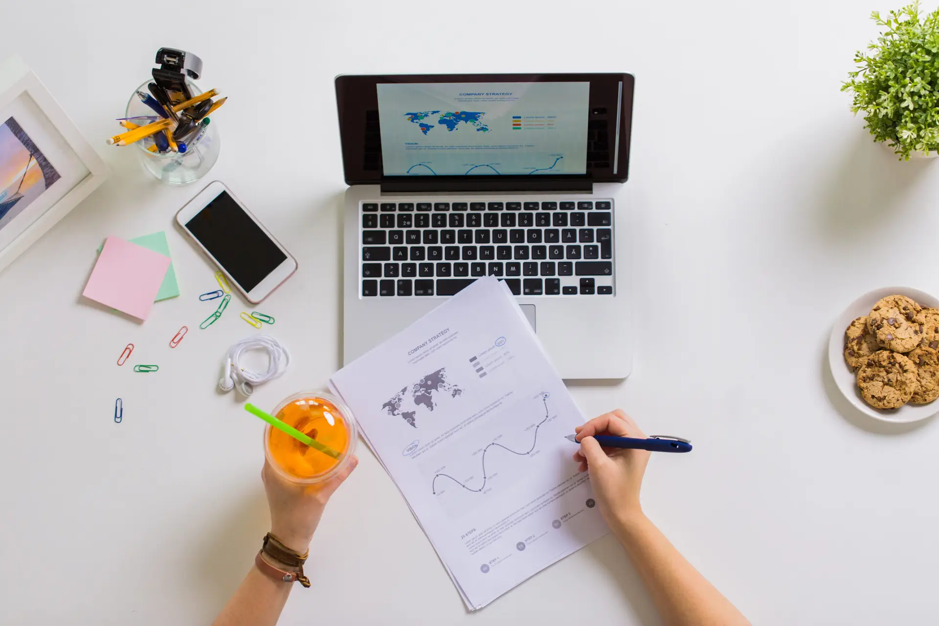 hands with laptop and papers at office table